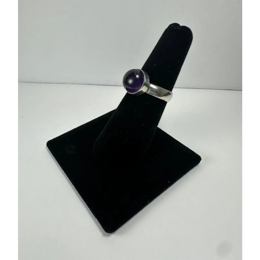 Sleek silver amethyst ring with smooth purple stone in minimalist band