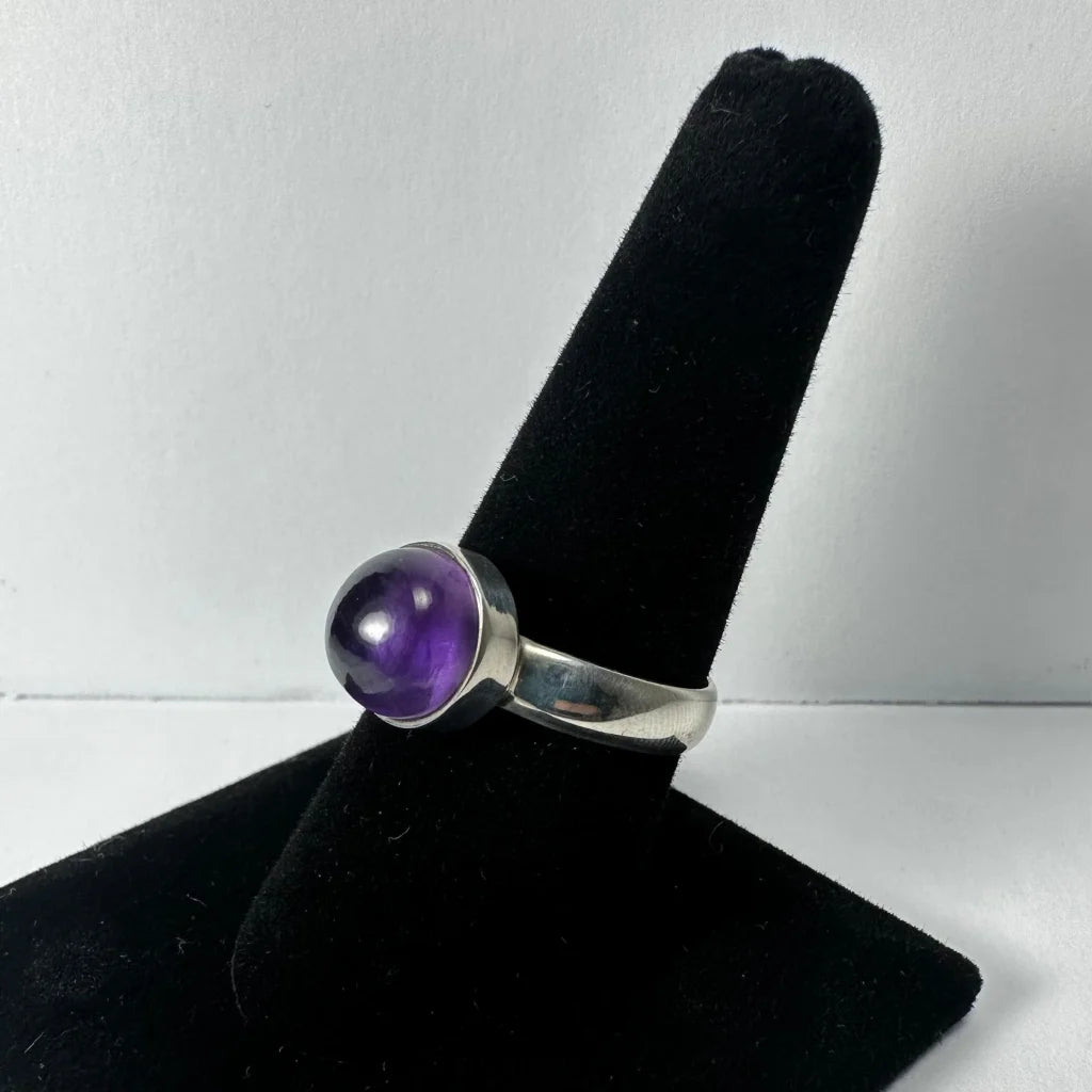 Sleek silver amethyst ring with round deep purple stone in bezel