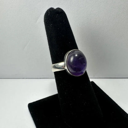 Sleek silver amethyst ring with oval purple stone in polished bezel