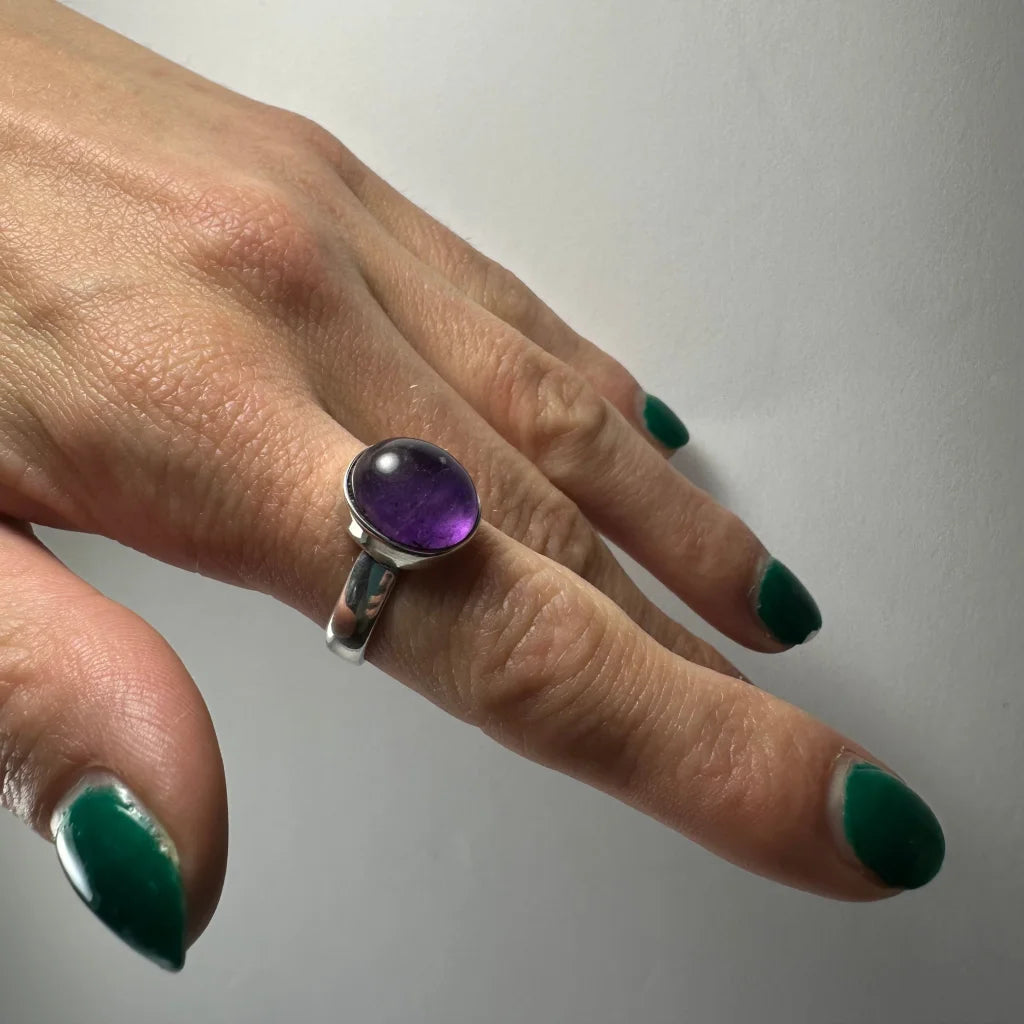 Sleek silver amethyst ring with oval purple stone