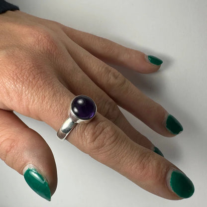Sleek silver amethyst ring with oval purple stone in minimalist band