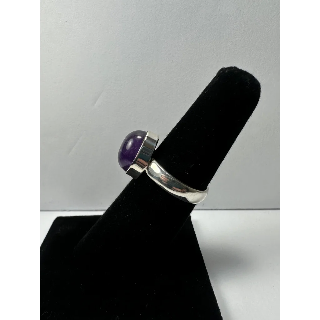Sleek silver amethyst ring with oval purple gem in minimalist band