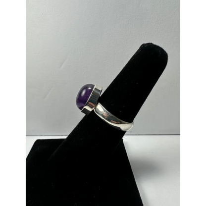 Sleek silver amethyst ring with oval purple gem in minimalist band