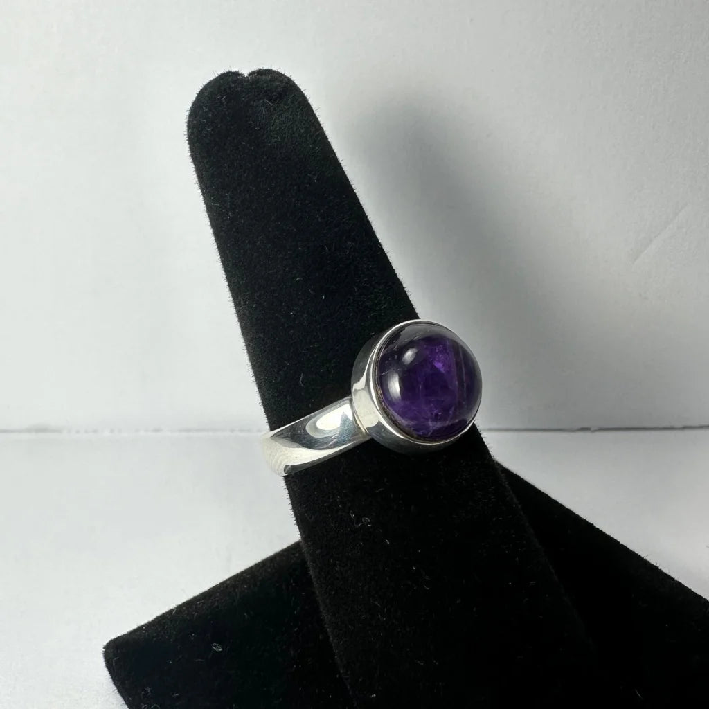 Sleek silver amethyst ring with oval purple stone in polished bezel