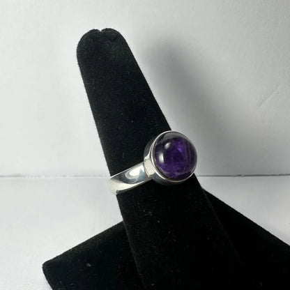 Sleek silver amethyst ring with oval purple stone in polished bezel