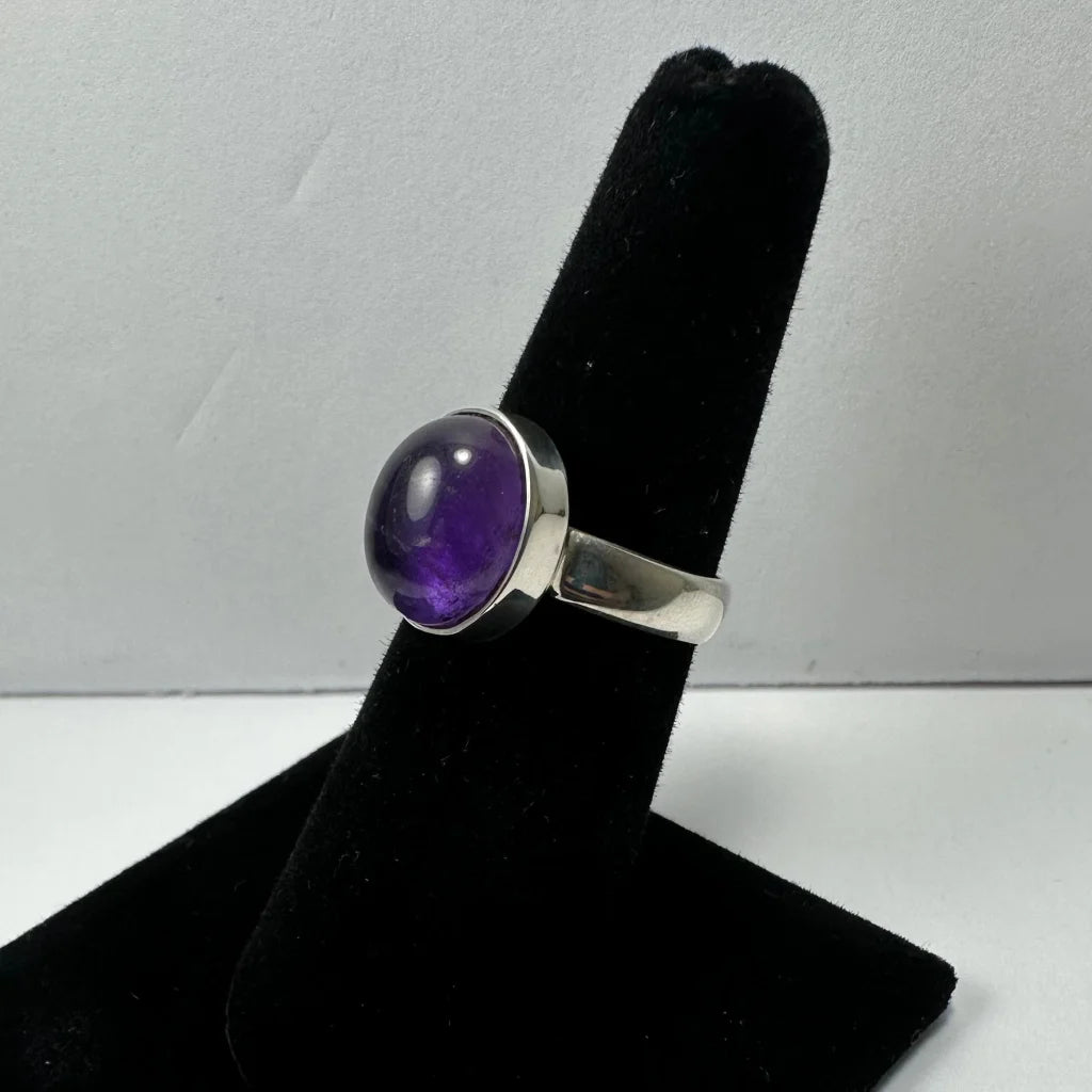 Sleek silver amethyst ring with oval purple stone in polished bezel