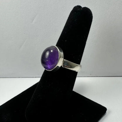 Sleek silver amethyst ring with oval purple stone in polished bezel
