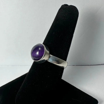 Sleek silver amethyst ring with deep purple round stone in bezel