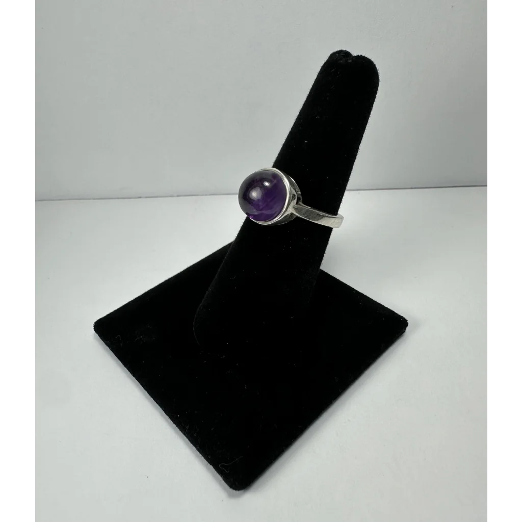 Sleek silver amethyst ring with deep purple round stone in bezel