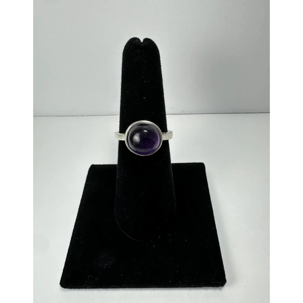 Sleek silver amethyst ring with smooth oval purple stone in bezel