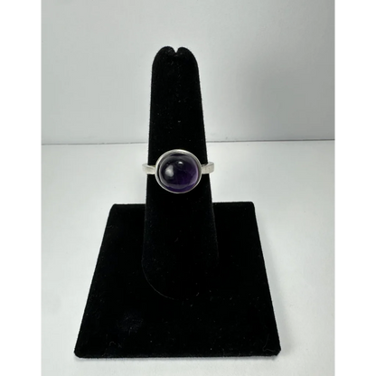 Sleek silver amethyst ring with smooth oval purple stone in bezel