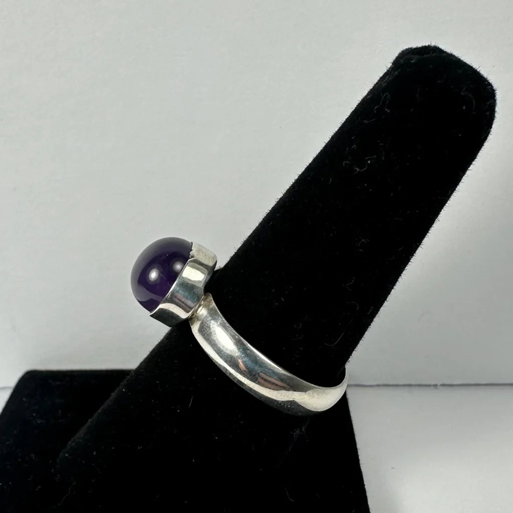 Sleek silver amethyst ring with smooth purple stone in polished band