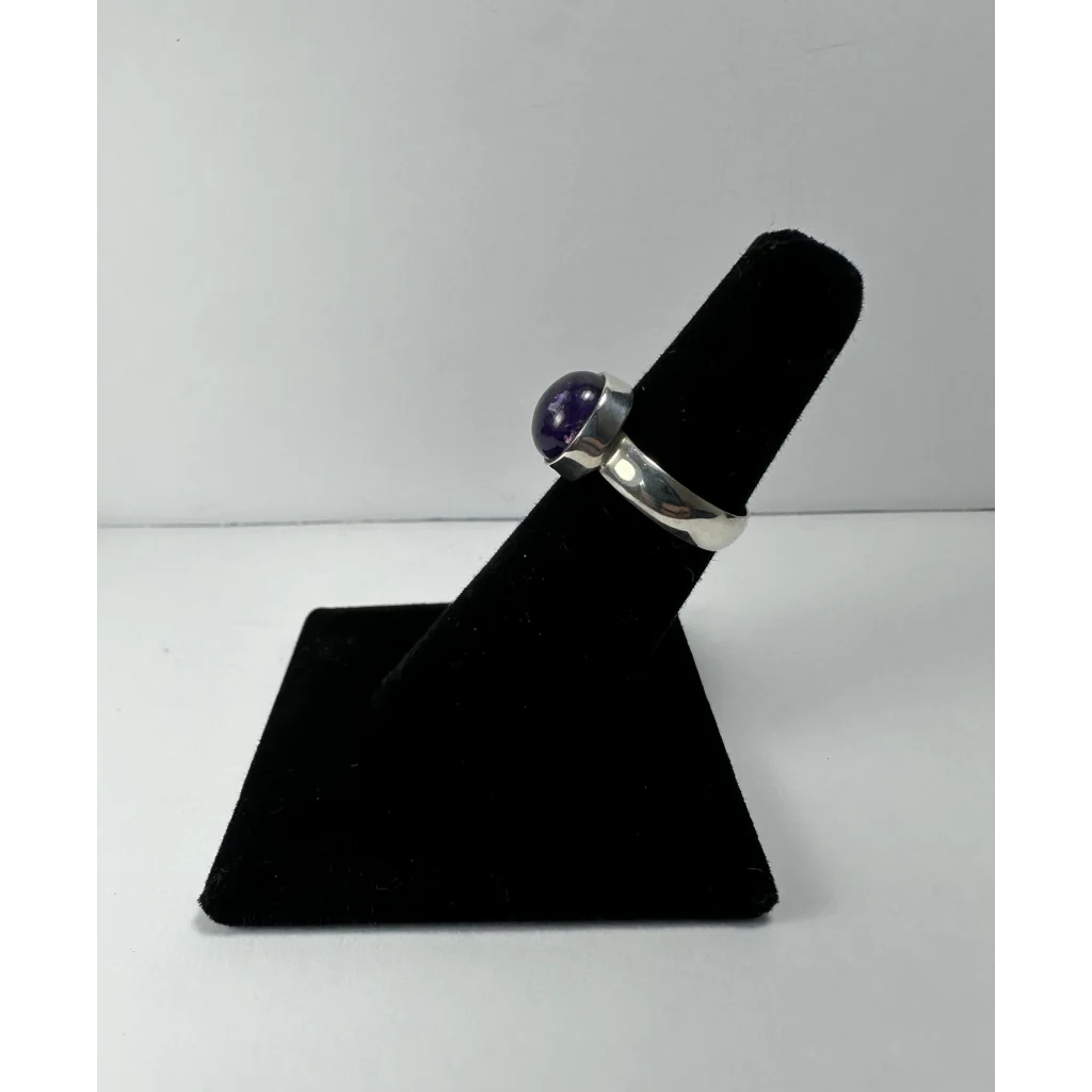 Sleek silver amethyst ring with smooth round purple gemstone