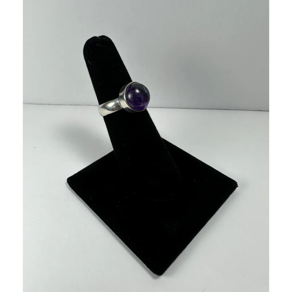 Sleek silver amethyst ring with smooth purple stone in polished band