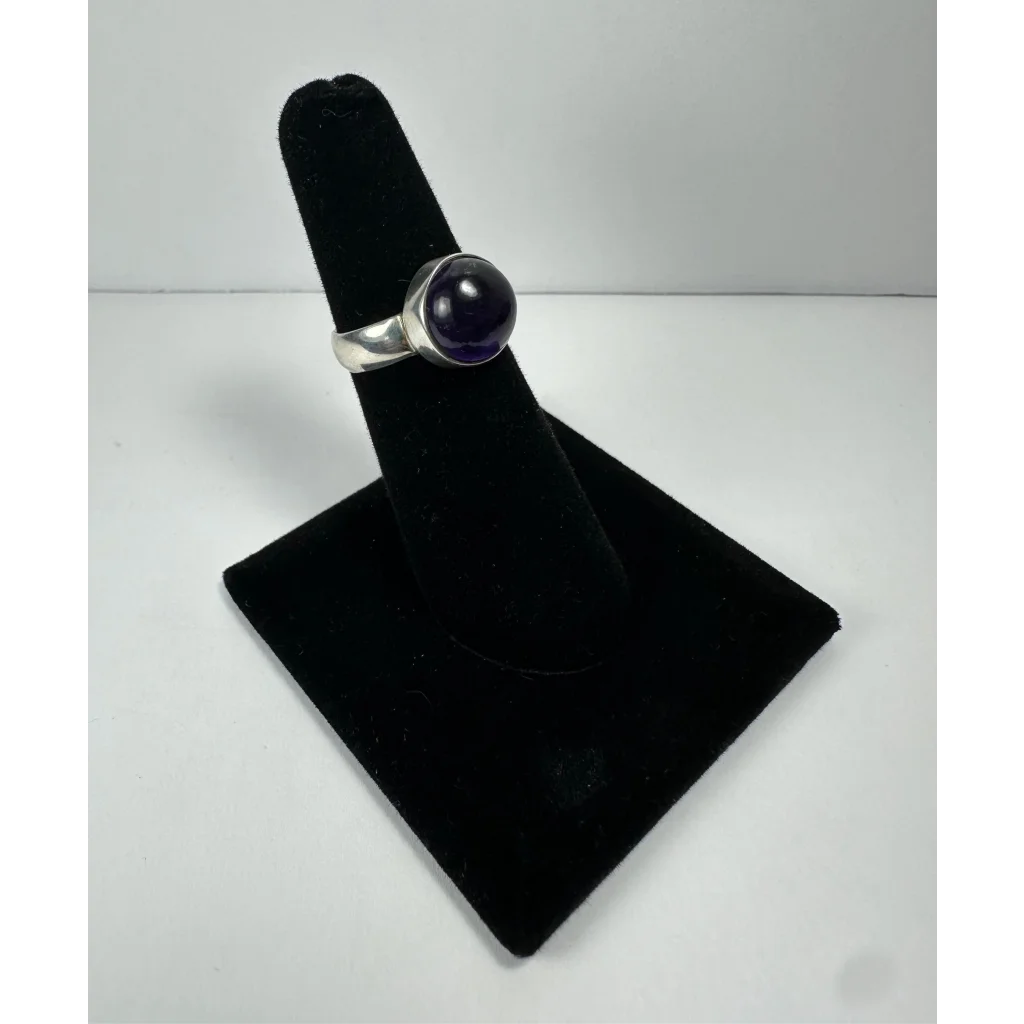 Sleek silver amethyst ring with smooth round stone in minimalist band
