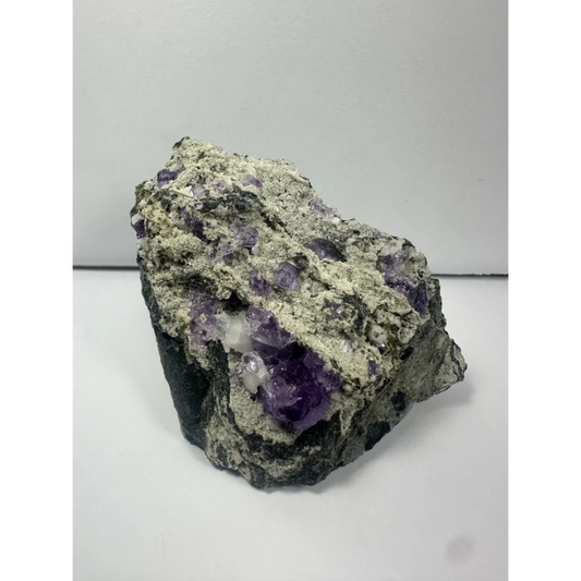 Rugged purple fluorite clusters on natural gray matrix from China