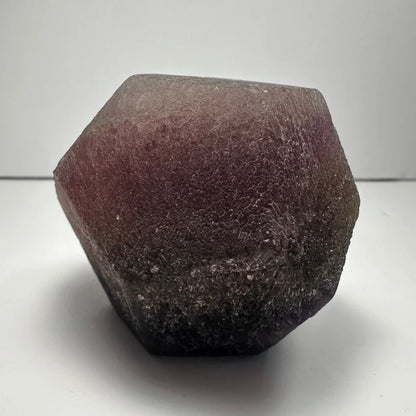 Stunning purple fluorite dodecahedron crystal geode with hexagonal translucent texture