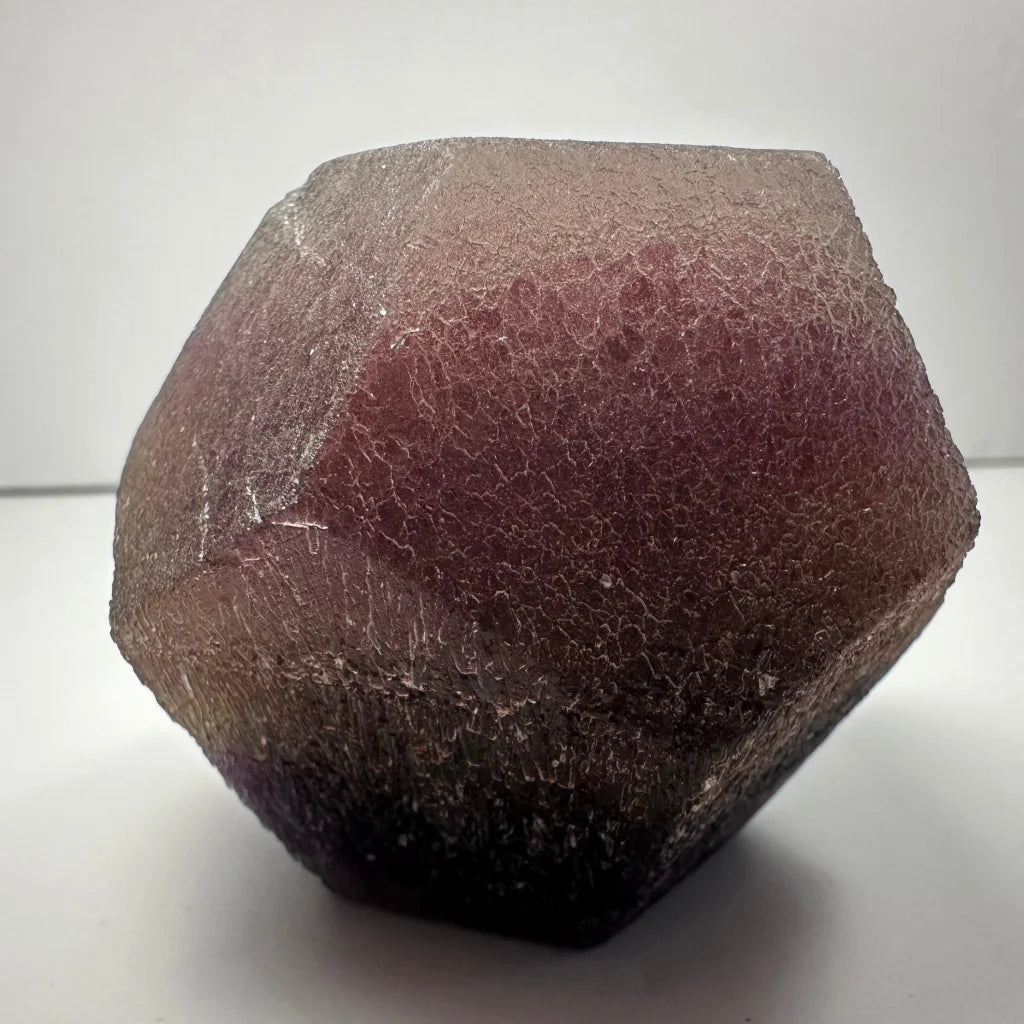 Stunning purple fluorite dodecahedron crystal geode with translucent facets