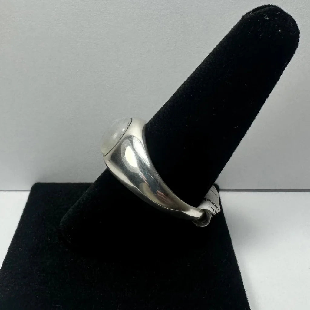 Sleek silver moonstone ring with oval white gem in rounded band