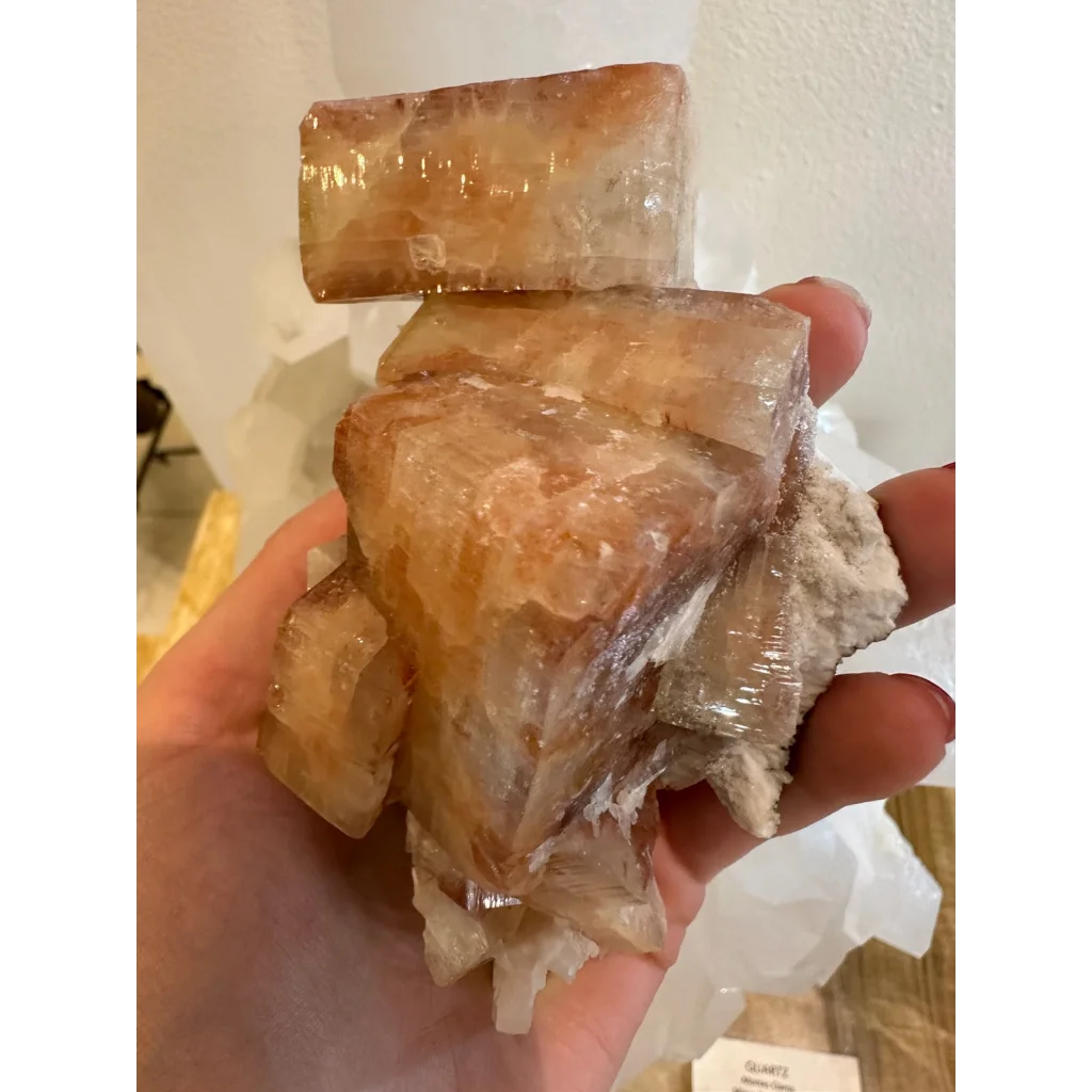 Hand holding stunning red apophyllite crystal cluster from Pune India