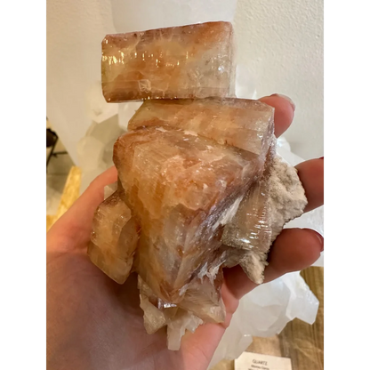 Hand holding stunning red apophyllite crystal cluster from Pune India