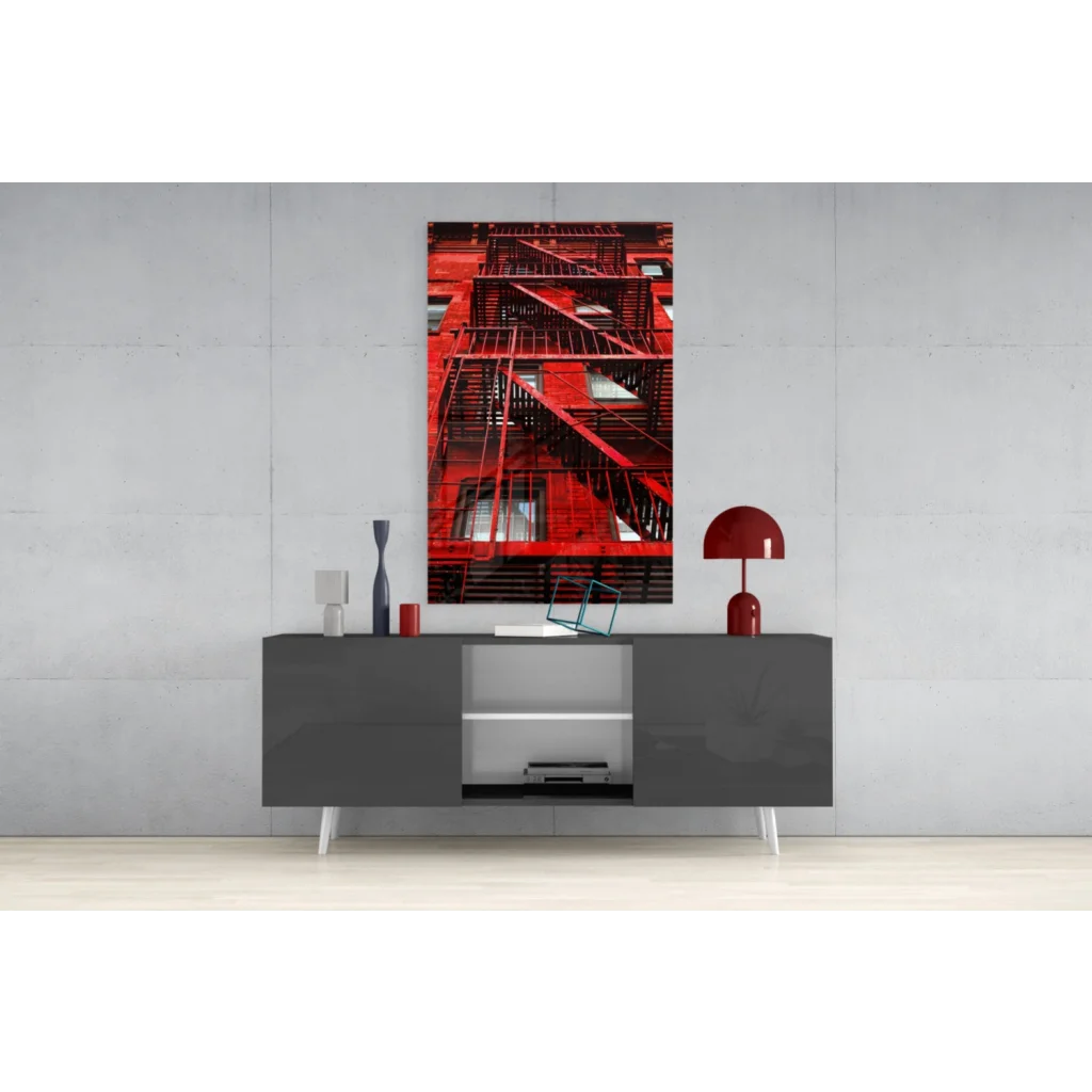 Vibrant red fire escape glass wall art on gray wall above console