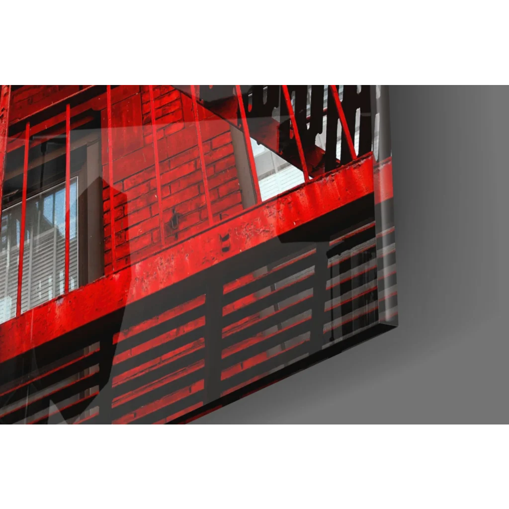 Vibrant red fire escape glass wall art print with bold railings and brick backdrop