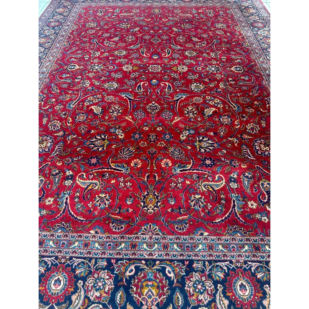 Vibrant red Persian rug with intricate floral and paisley patterns in navy, gold, and cream