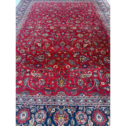 Vibrant red Persian rug with intricate floral and paisley patterns in navy, gold, and cream