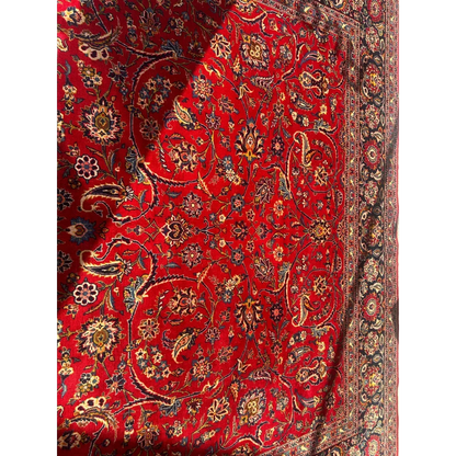 Vibrant red Persian rug with intricate floral patterns in gold, blue, black