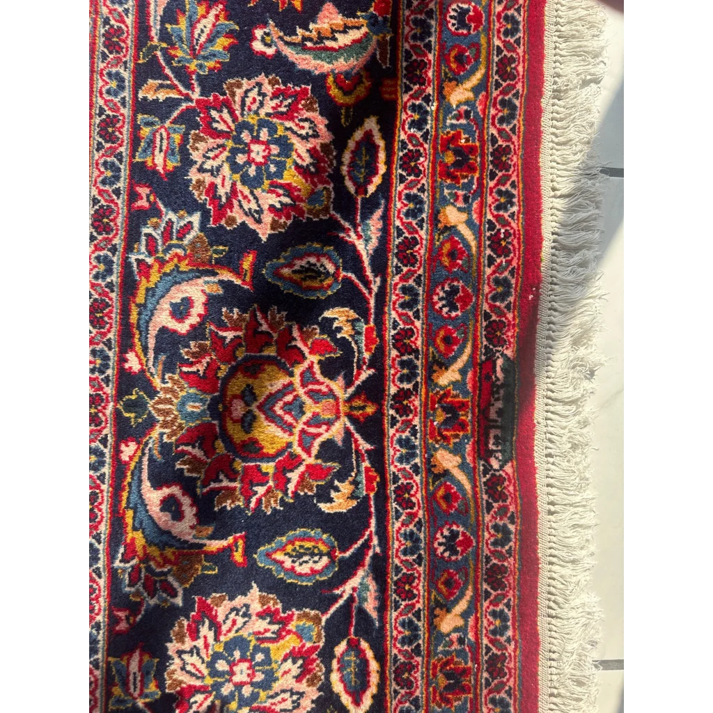 Stunning red Persian rug with intricate floral patterns in dark blue