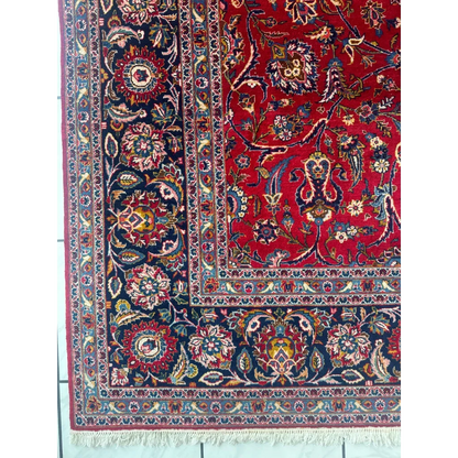 Vibrant red Persian rug with intricate floral and paisley patterns in navy, gold, and cream