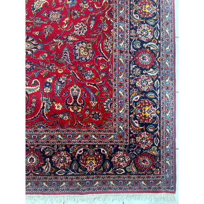 Stunning red Persian rug with intricate floral and vine patterns in navy, gold, and cream