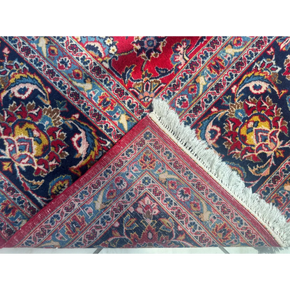 Stunning red Persian rug with vibrant navy details and intricate floral patterns