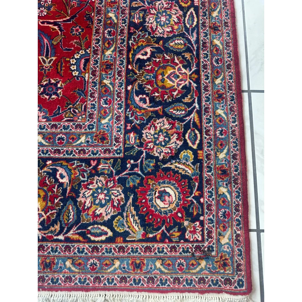 Stunning red Persian rug with intricate floral and vine patterns in navy, gold, cream