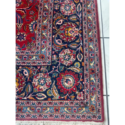 Stunning red Persian rug with intricate floral and vine patterns in navy, gold, cream