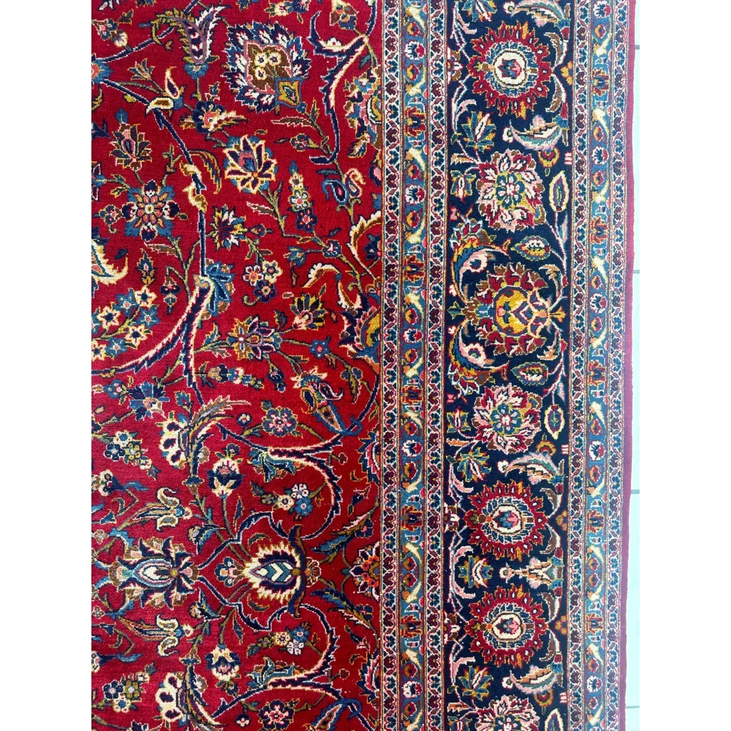 Stunning red Persian rug with intricate floral and vine patterns in navy, gold, and cream