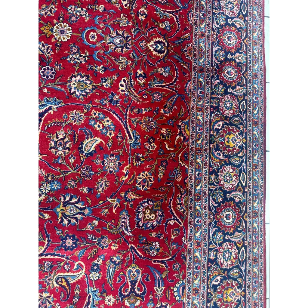 Stunning red Persian rug with intricate floral and paisley patterns in navy, gold, cream wool