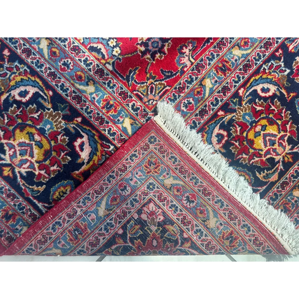 Stunning red persian rug with vibrant navy tones and intricate floral patterns