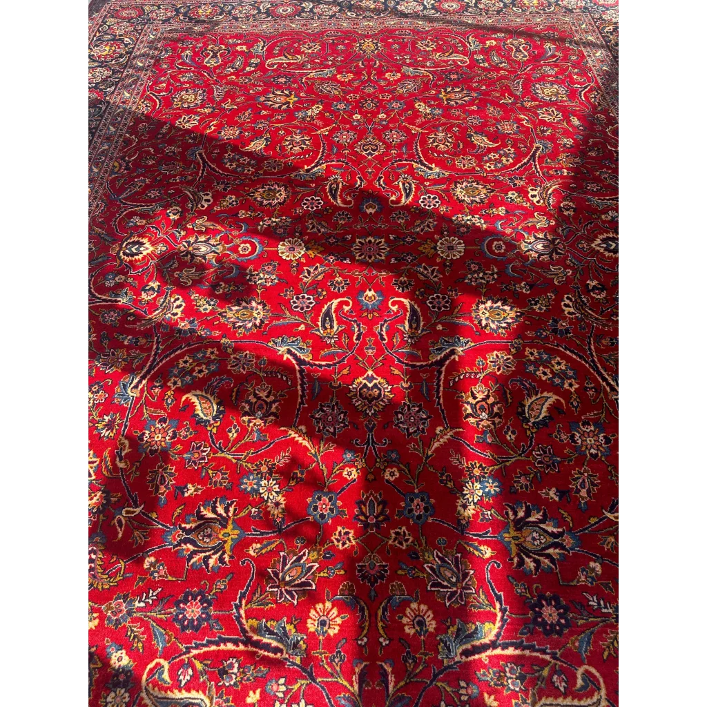 Vibrant red Persian rug with intricate floral and paisley patterns in gold, blue, black