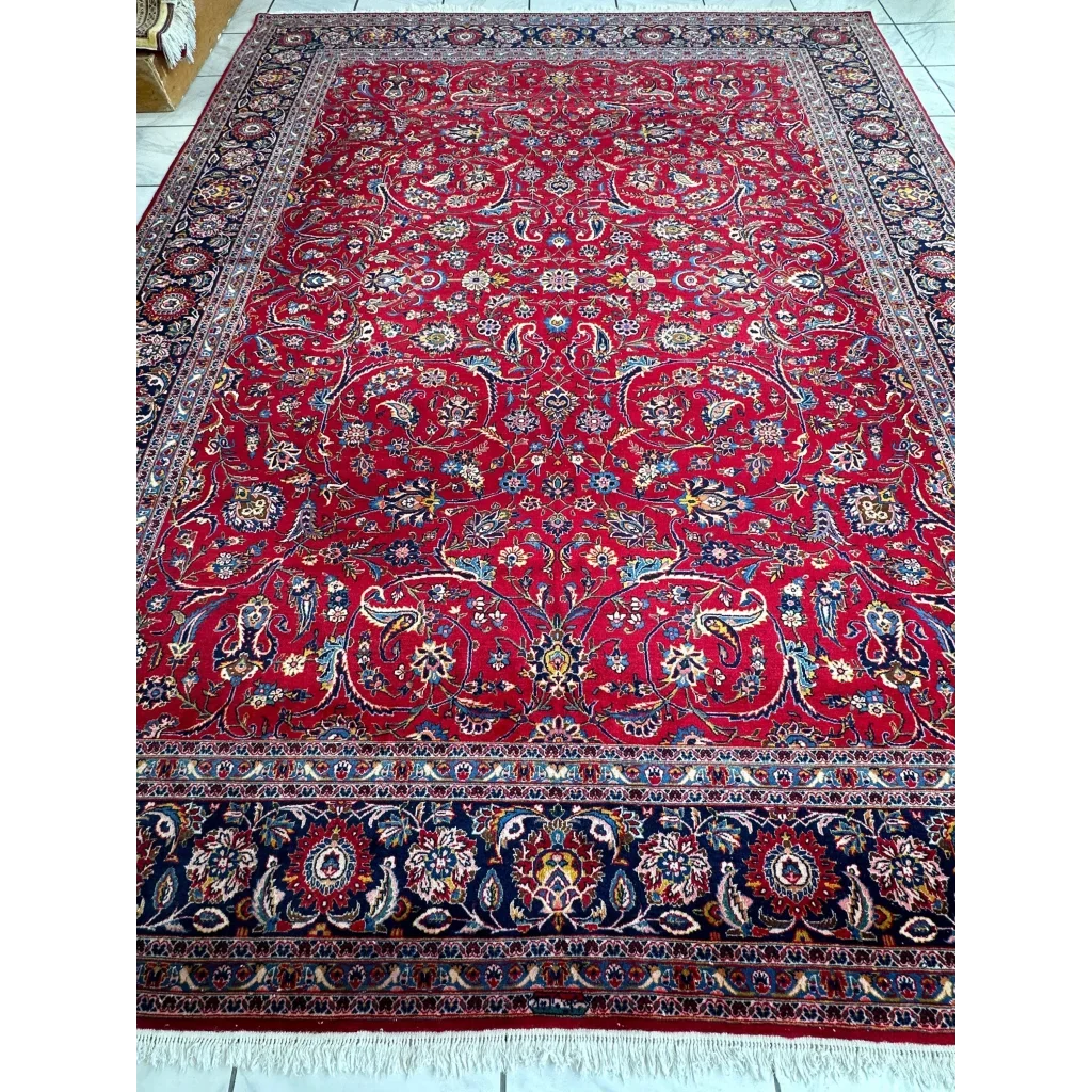 Vintage 1960s Persian red rug with intricate floral and paisley patterns in gold, blue, and ivory