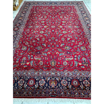 Vintage 1960s Persian red rug with intricate floral and paisley patterns in gold, blue, and ivory