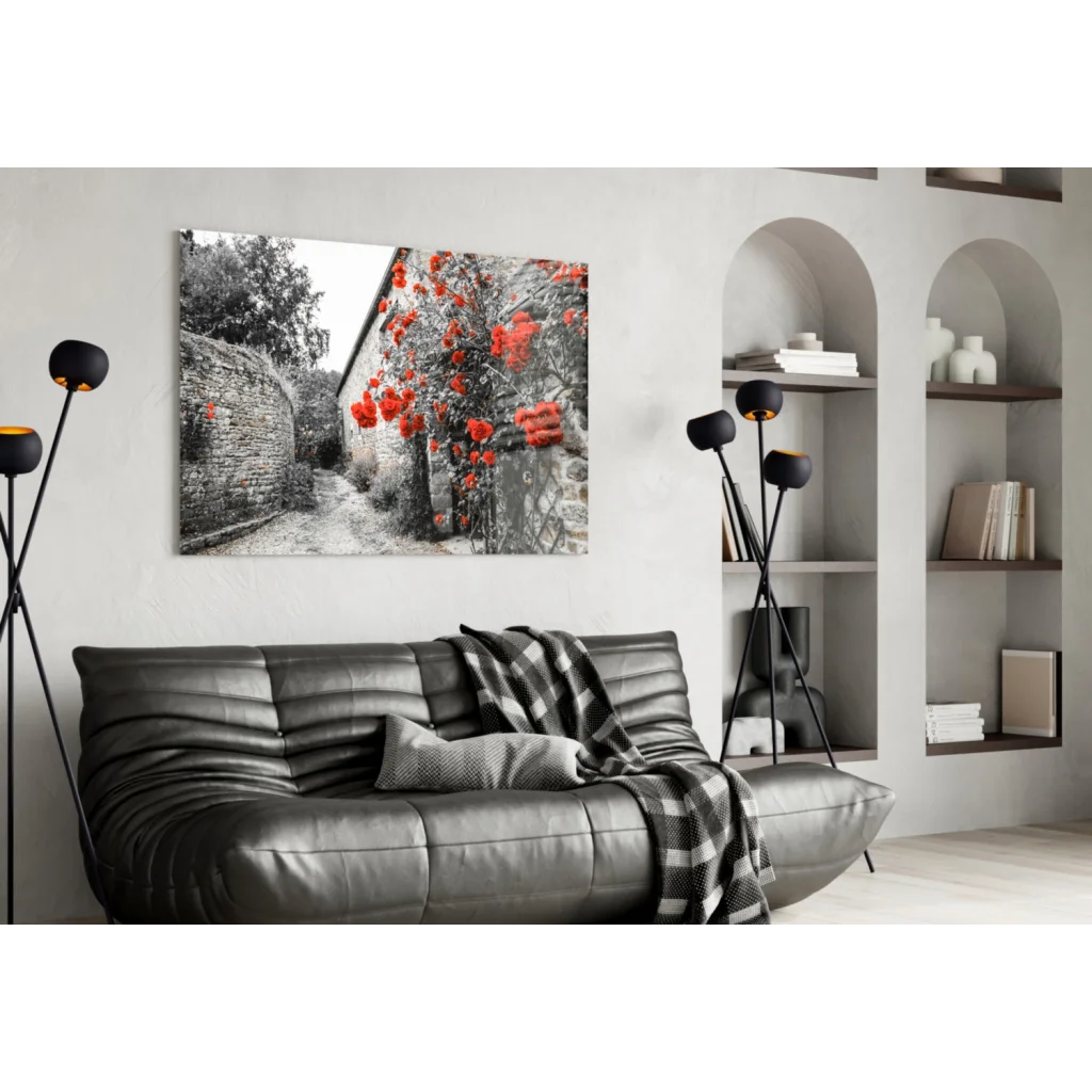 Black leather sofa with plaid throw and Stunning Red Rose Barn wall art