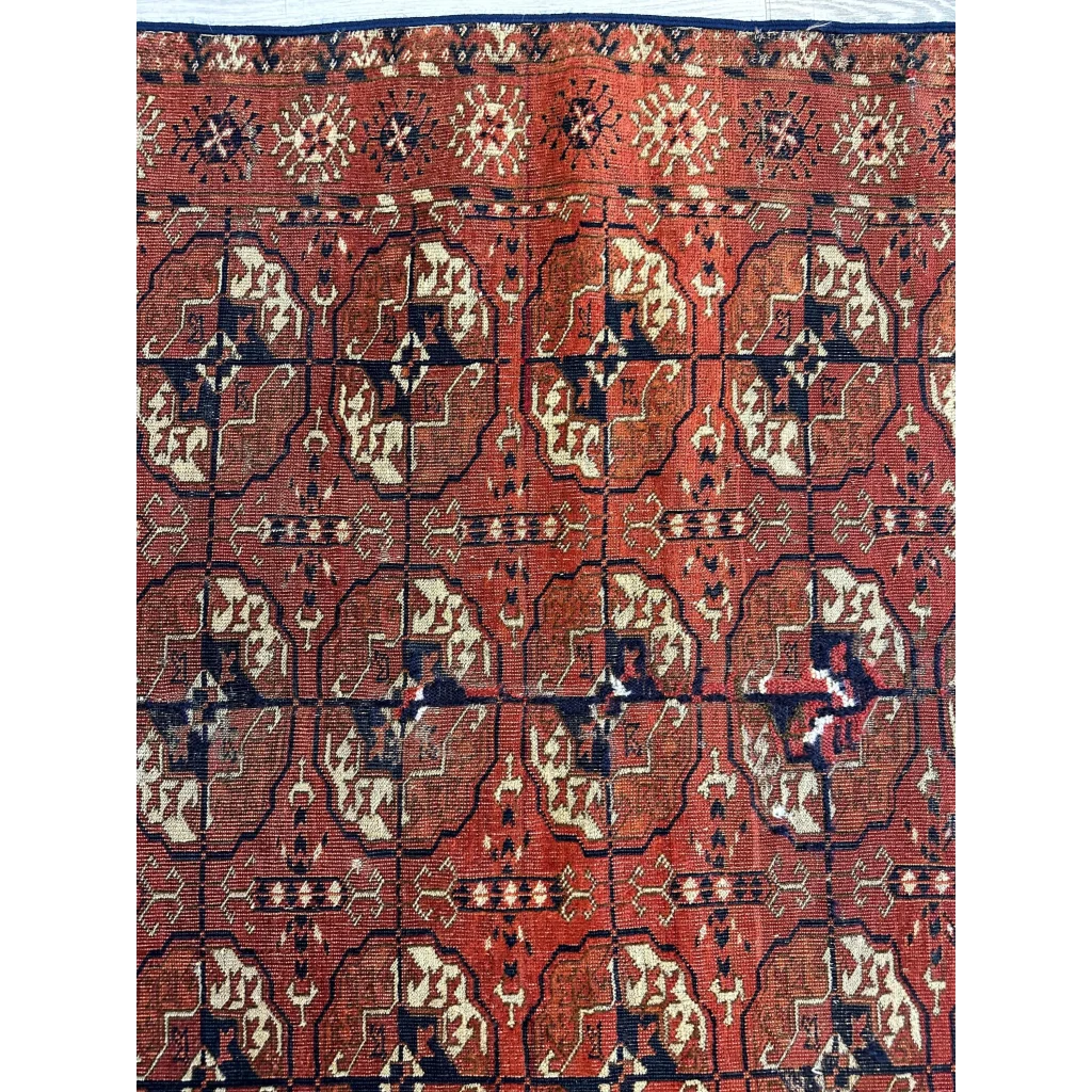 Rich red Turkmen Persian rug with geometric floral patterns