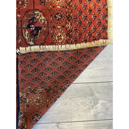 Stunning red Turkmen Persian rug with black geometric florals