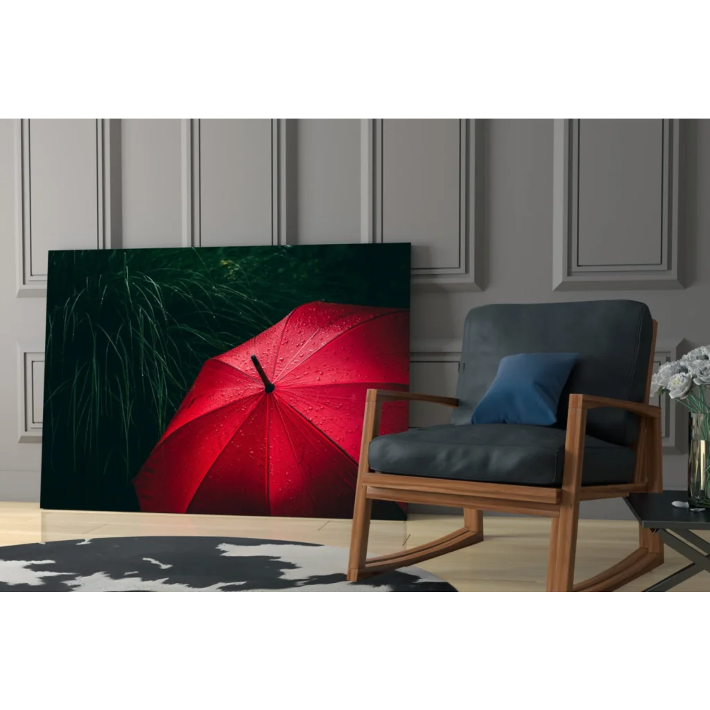 Vibrant red umbrella wall art print on canvas amid dark green foliage