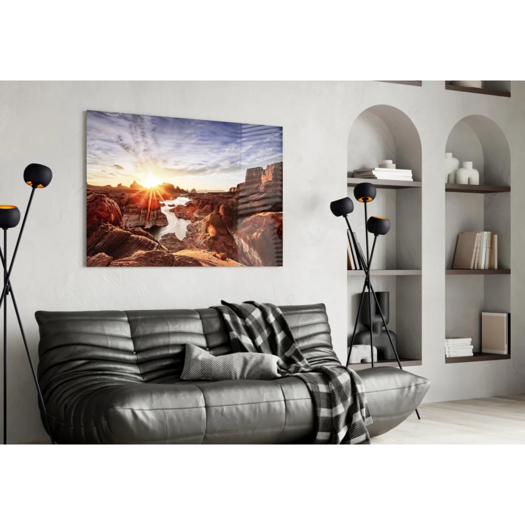 Stunning Rocky Beach Sunset wall art with leather couch and checkered blanket