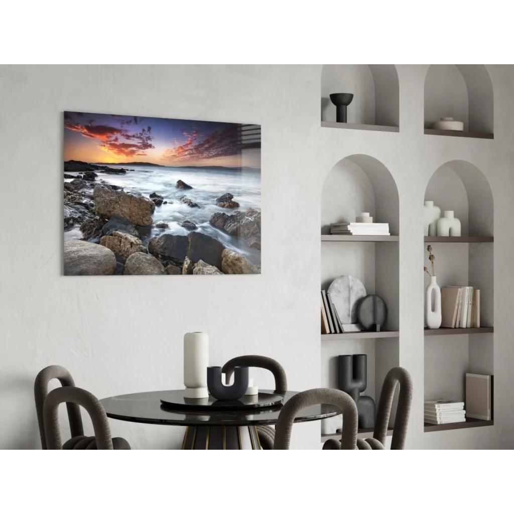 Vibrant rocky beach sunset wall art on modern black round dining table
