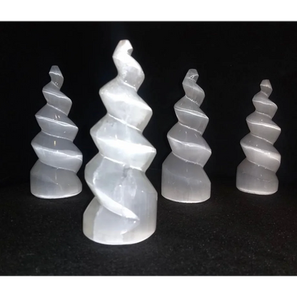 Four translucent white selenite spiral towers from Morocco, polished helical twists
