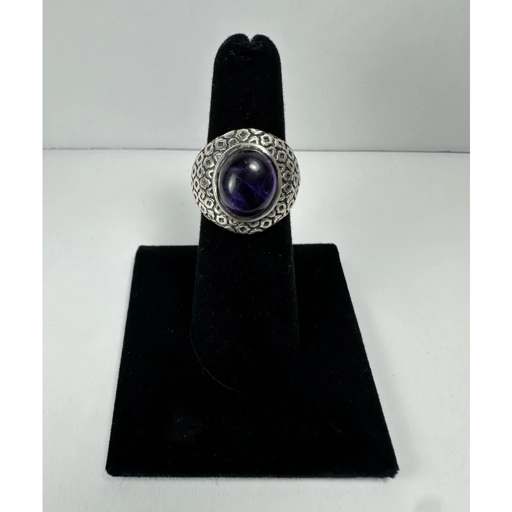 Stunning silver amethyst ring with geometric textured band and oval purple gem